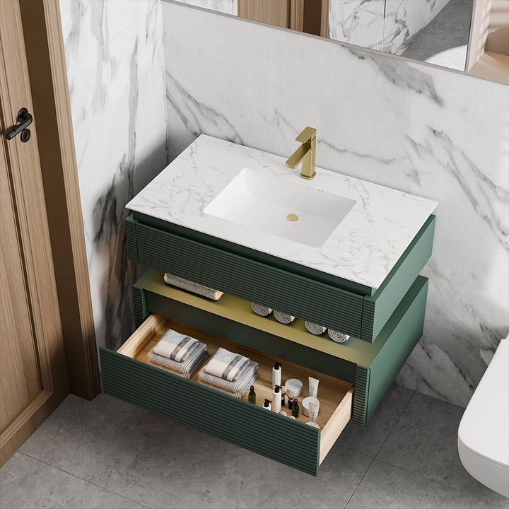 Green fluted bathroom vanity with drawer storage and marble countertop