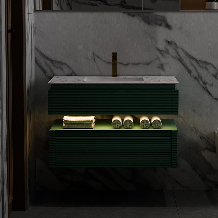 Green fluted bathroom vanity with LED lighting and marble top