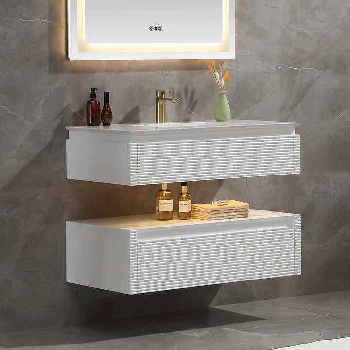 White wall mounted bathroom vanity with marble countertop and light