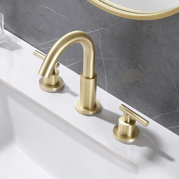 Angled view brushed gold widespread faucet on bathroom counter