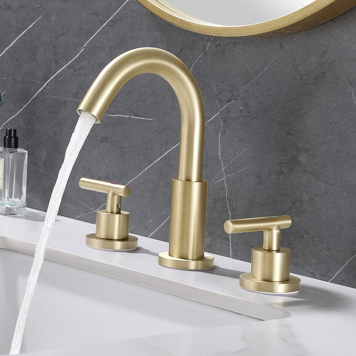 Brushed gold widespread faucet running water on bathroom sink