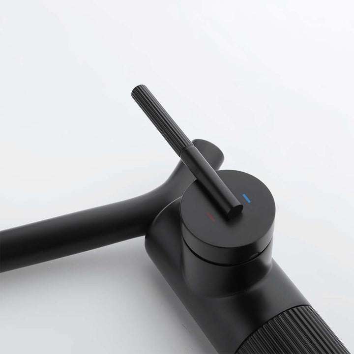 Close-up of bathroom faucet handle with hot and cold indicators
