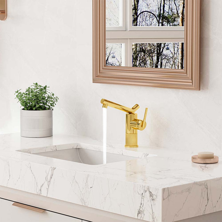 Modern gold bathroom faucet on marble vanity countertop