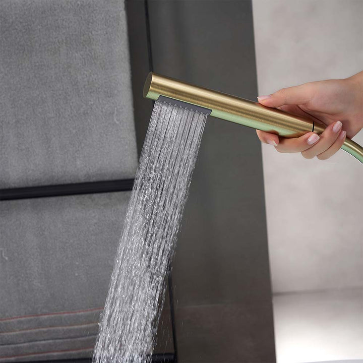 Gold handheld shower head spraying water in hand