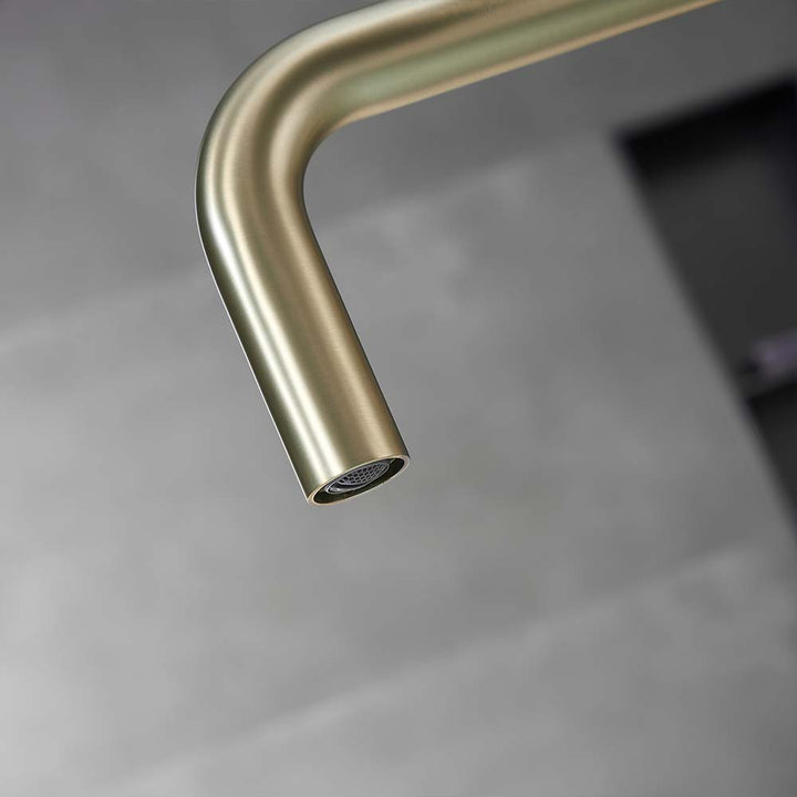 Close-up of gold square spout faucet water outlet