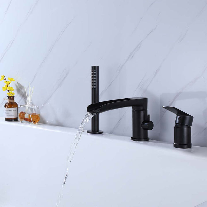 Black bathtub faucet with waterfall spout in use