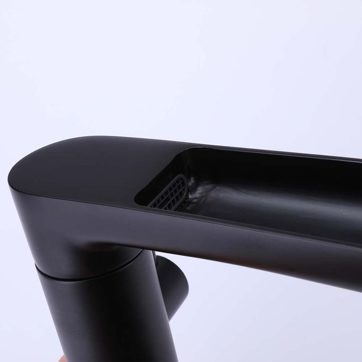 Close-up of black bathtub faucet waterfall spout