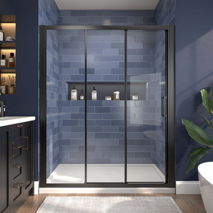 Black-framed sliding shower door with clear glass and blue tiled wall background.