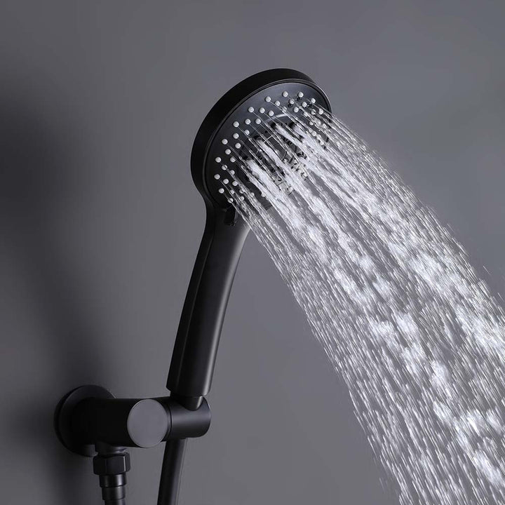 Black handheld shower head spraying water in wide fan pattern