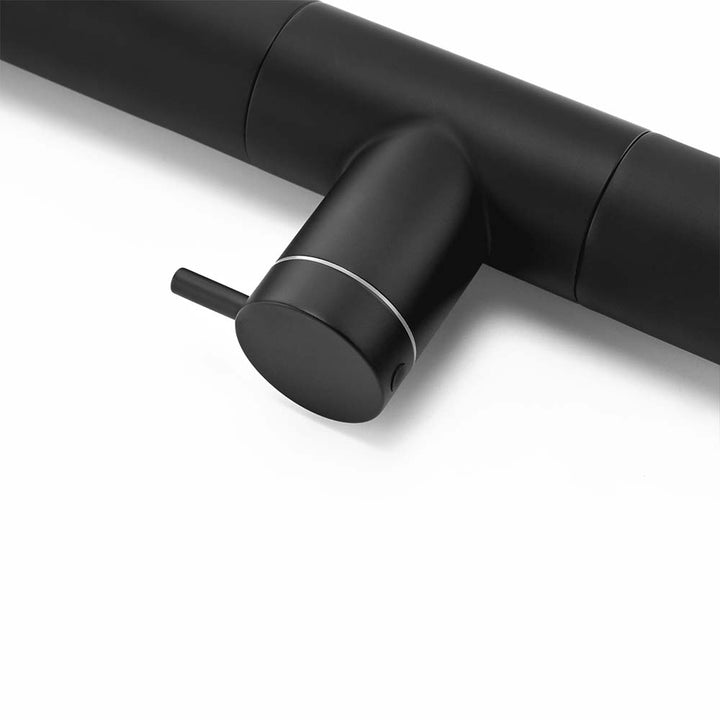 Close-up of the black control valve on an outdoor shower with sleek modern design