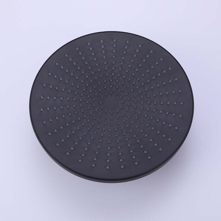 Black round rain shower head detail view with silicone nozzles
