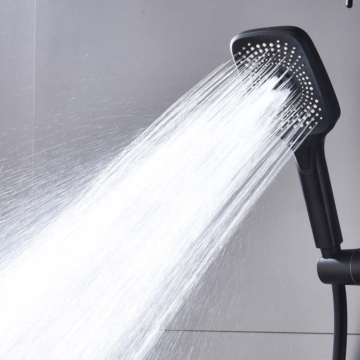 Matte black handheld shower spraying water from shower system.