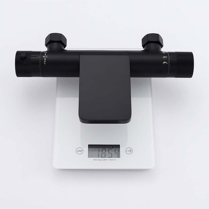 Black shower system thermostatic faucet showing weight on scale