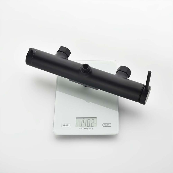 Black shower system valve body showing 1482g weight on scale