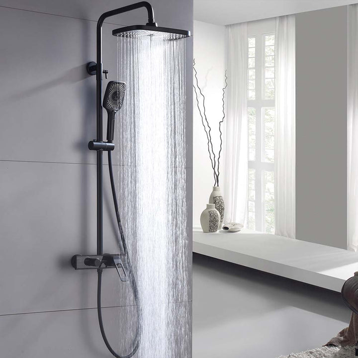 Black shower system showing full rainfall water flow in modern bathroom