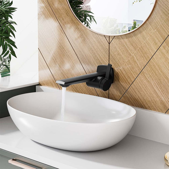 Black wall-mounted faucet with running water over white vessel sink