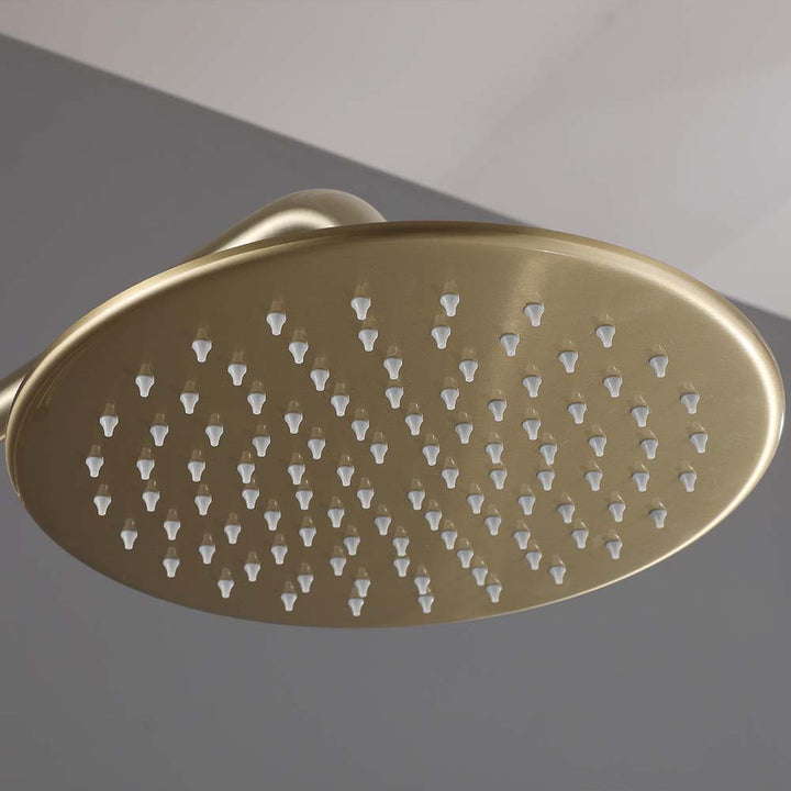 Close-up of brushed gold round shower head nozzles