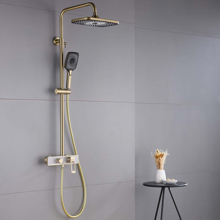 Brushed gold shower system installed in modern gray bathroom
