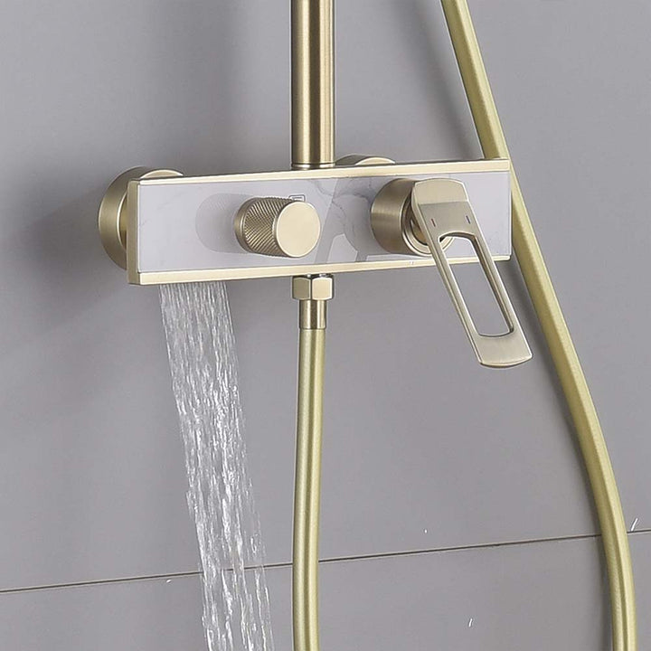 Brushed gold shower system with water flowing from tub spout.