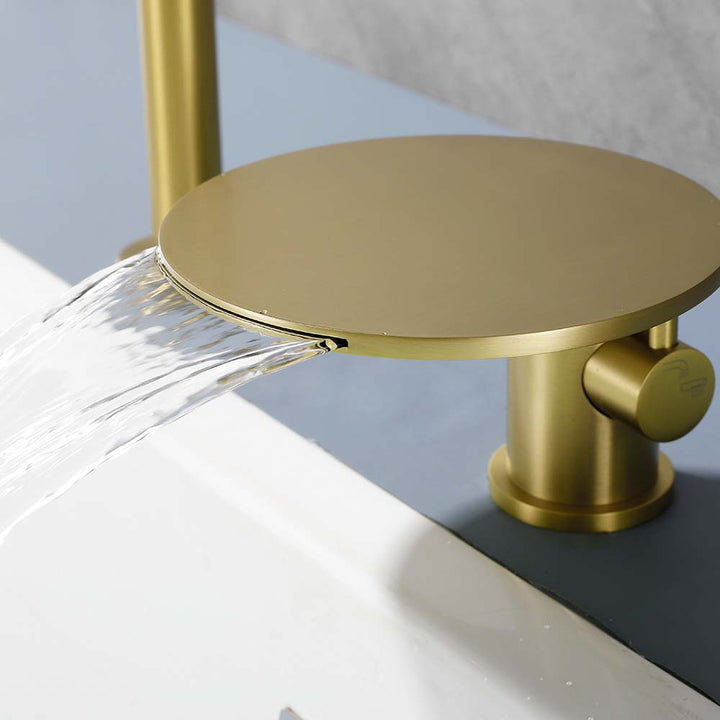 Brushed gold waterfall bathtub faucet close up