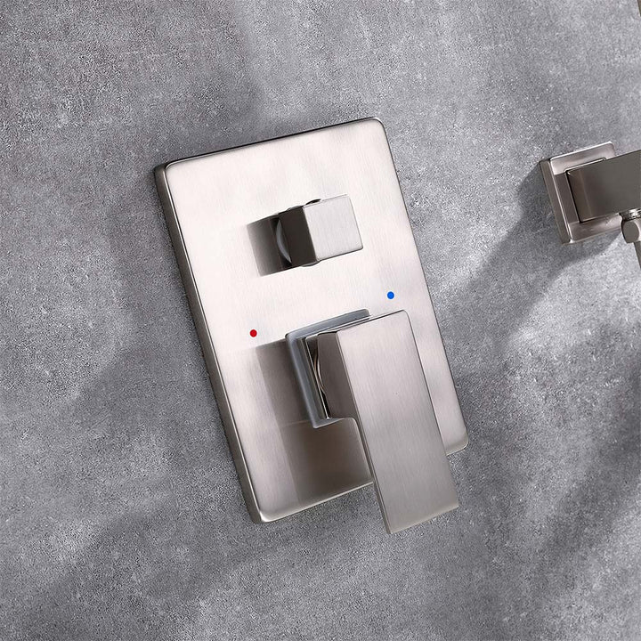 Close-up of brushed nickel bathtub faucet valve and diverter