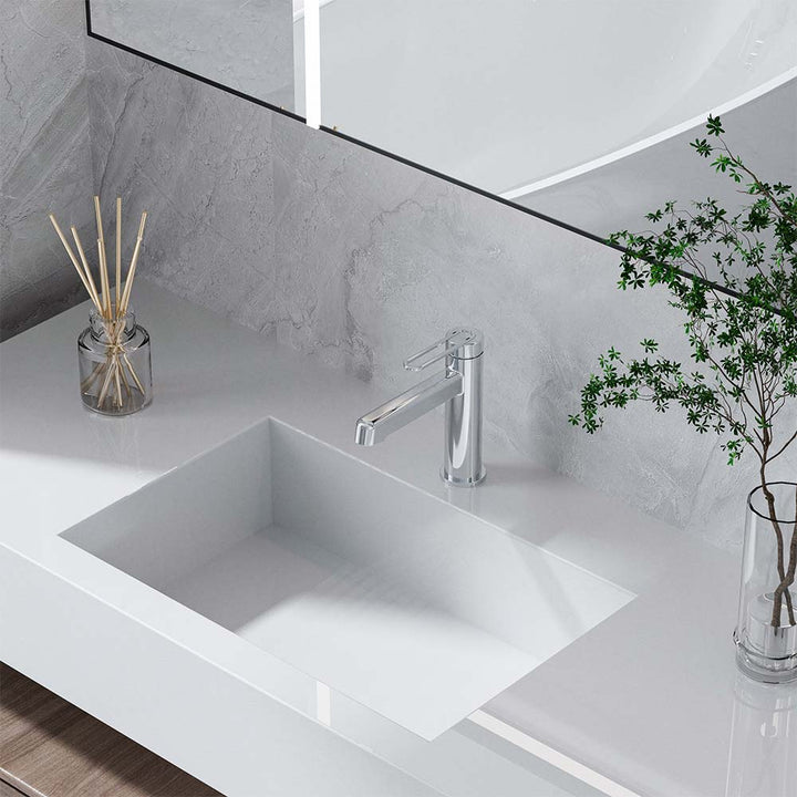 Chrome bathroom faucet installed on modern white vanity