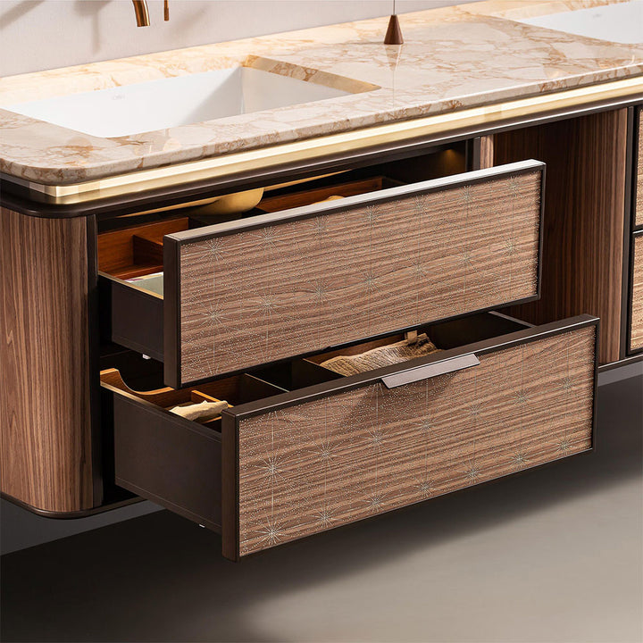 Open drawers of light wood custom bathroom vanity with marble countertop