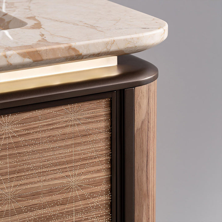 Close up of marble edge and light wood cabinet detail on custom bathroom vanity