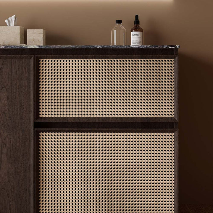 Rattan drawer detail of custom bathroom vanity in walnut wood finish