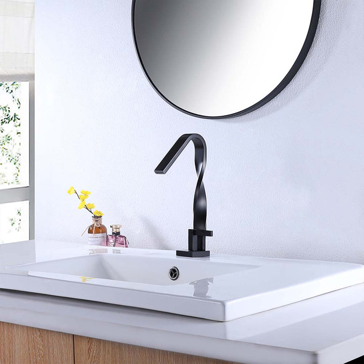 Black twisted faucet on white vanity with round mirror above