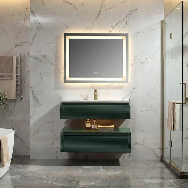 Floating dark green ribbed bathroom vanity with double drawers, white countertop, brass faucet, and a backlit LED mirror in a modern marble-look bathroom