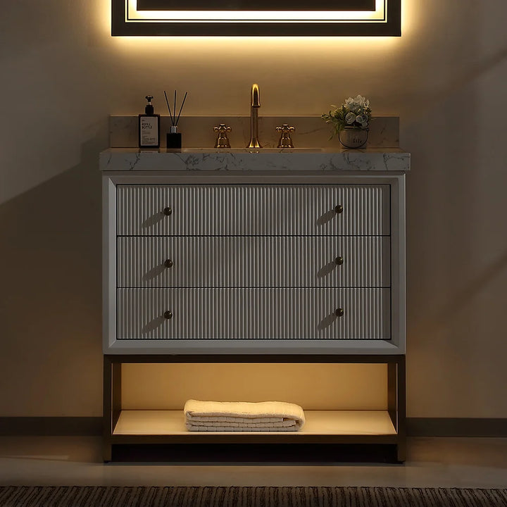 White fluted solid wood bathroom vanity with marble top in warm night light