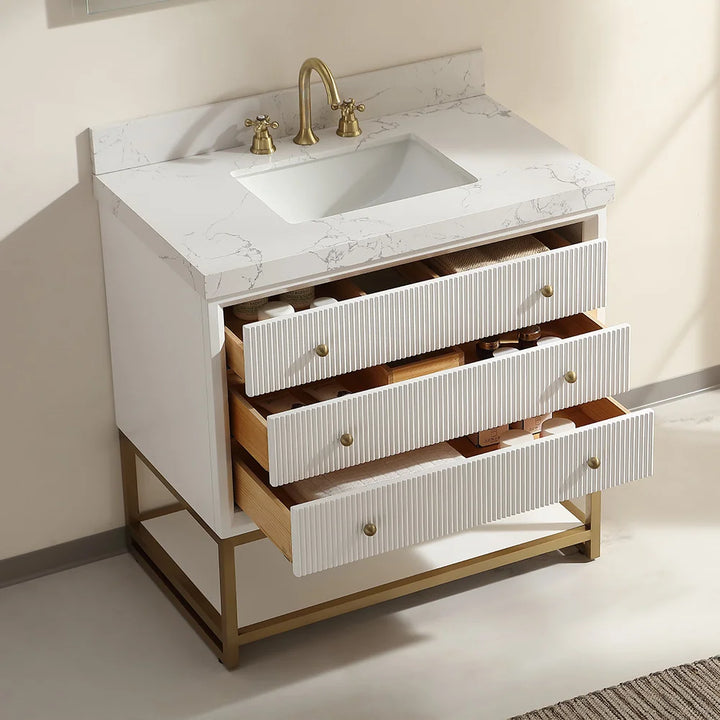 White fluted solid wood bathroom vanity with open drawers and gold faucet
