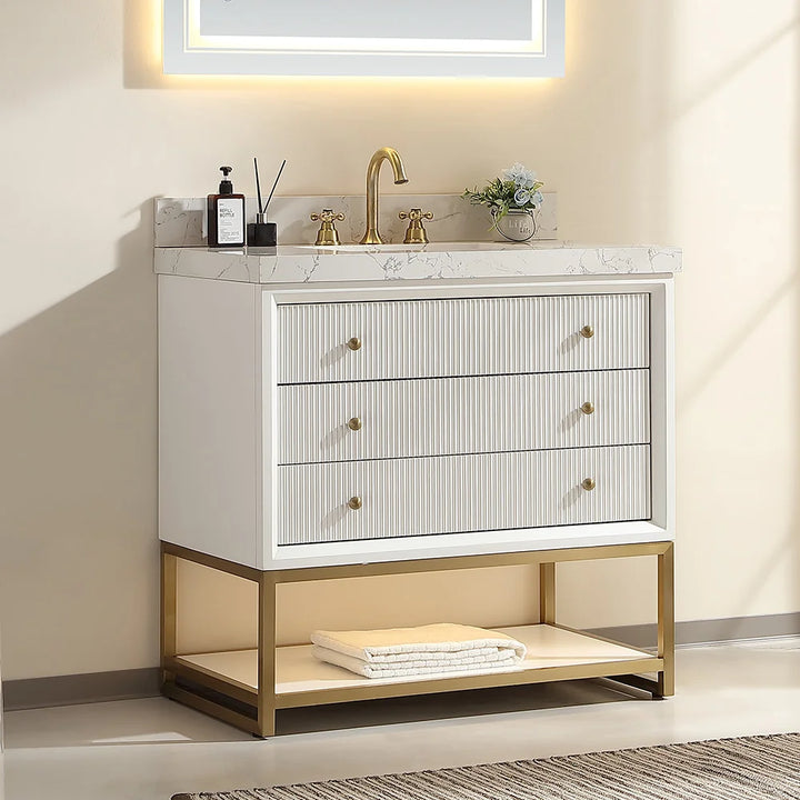White fluted solid wood bathroom vanity with marble top and gold faucet
