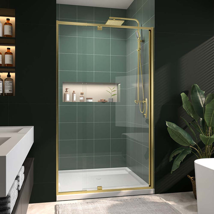 Gold framed glass shower door in modern green tile bathroom