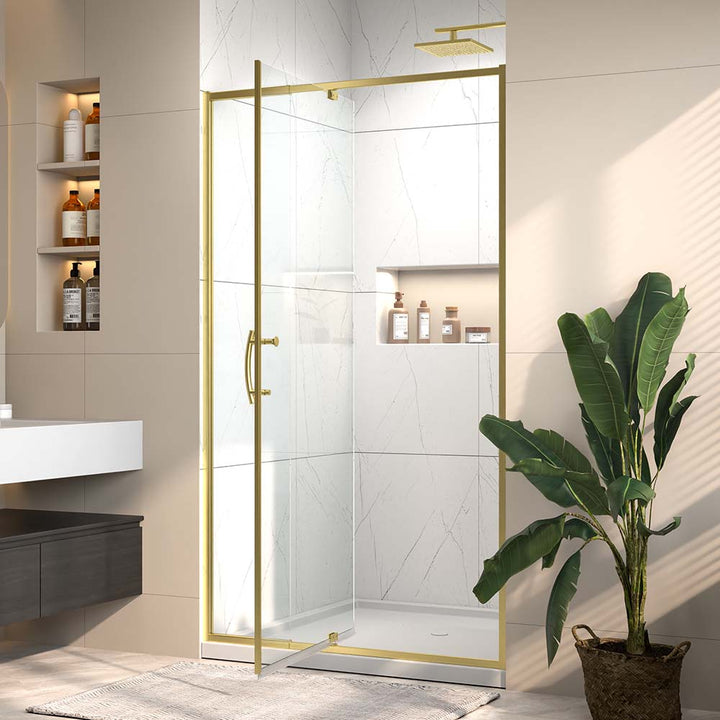 Gold framed pivot shower door open in modern marble bathroom
