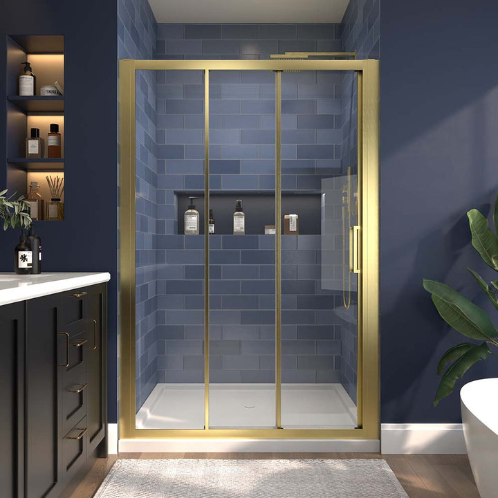 Gold-framed sliding shower door in a modern bathroom with blue tiles