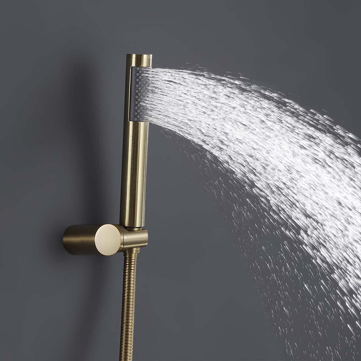 Gold handheld shower head in use with water spray close-up