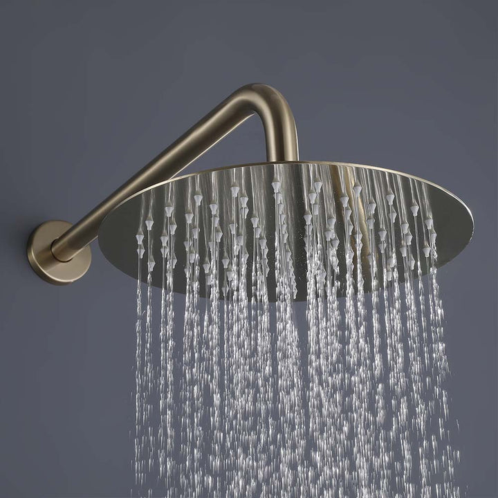 Gold rain shower head in use with water flow close-up view