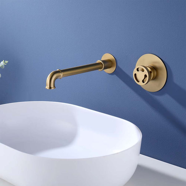 Gold wall mounted bathroom faucet above white basin