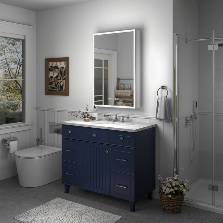 LED mirror medicine cabinet over blue vanity in modern bathroom