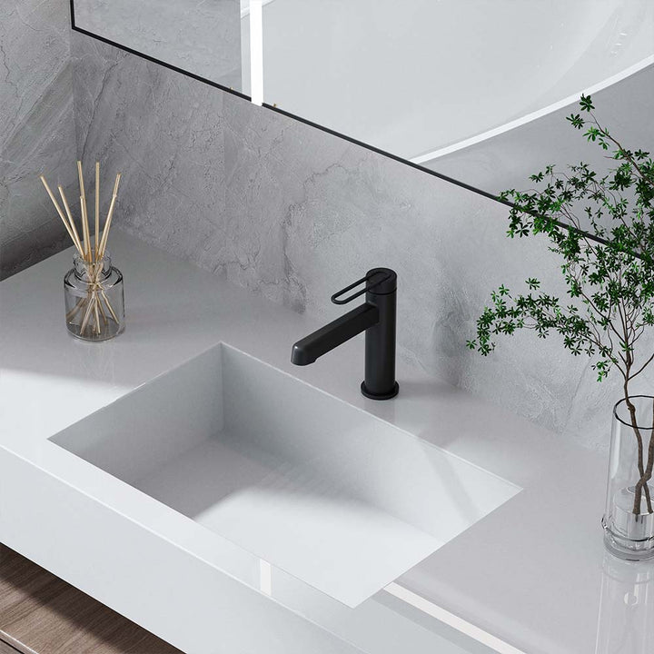 Close-up of matte black faucet on white bathroom vanity