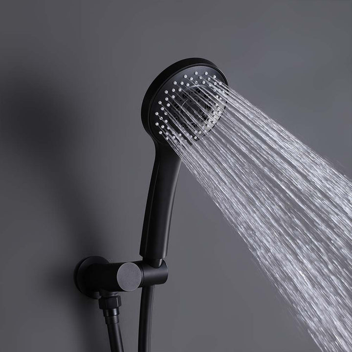 Matte black handheld shower spraying water on gray background
