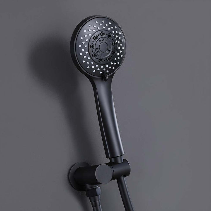 Matte black handheld shower head mounted on bathroom wall