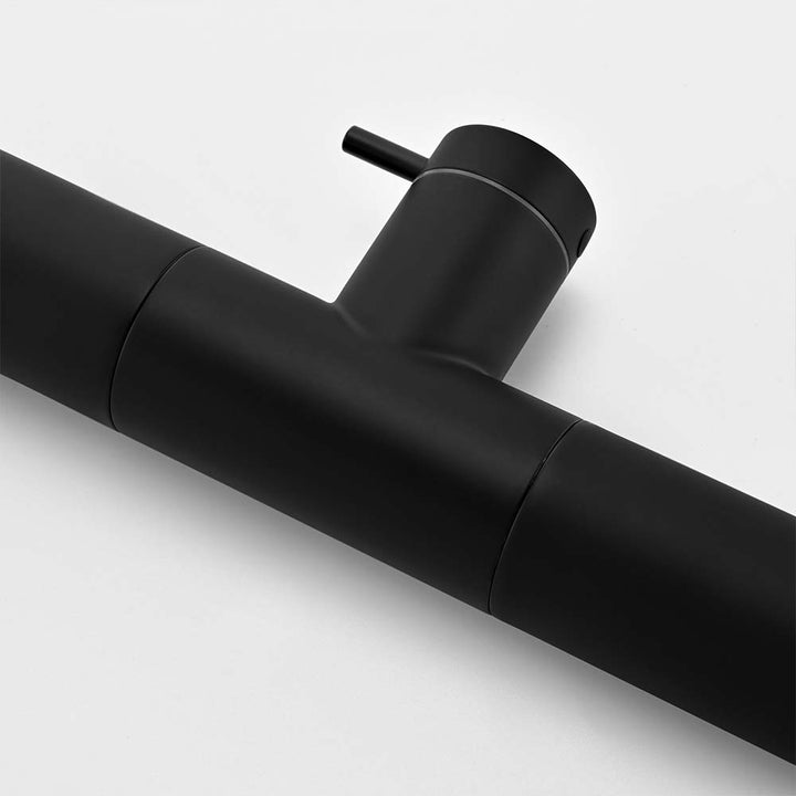 Matte black outdoor shower main water control switch close-up on white background