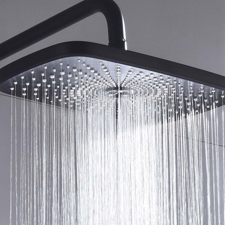 Close-up of matte black rain shower head with flowing water streams.