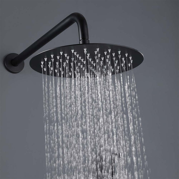 Matte black rain shower head spraying water in modern bathroom