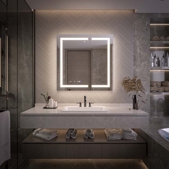 LED illuminated medicine cabinet above marble bathroom vanity.