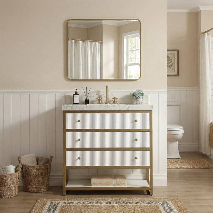 White fluted 3-drawer freestanding bathroom vanity with gold metal frame and white stone countertop
