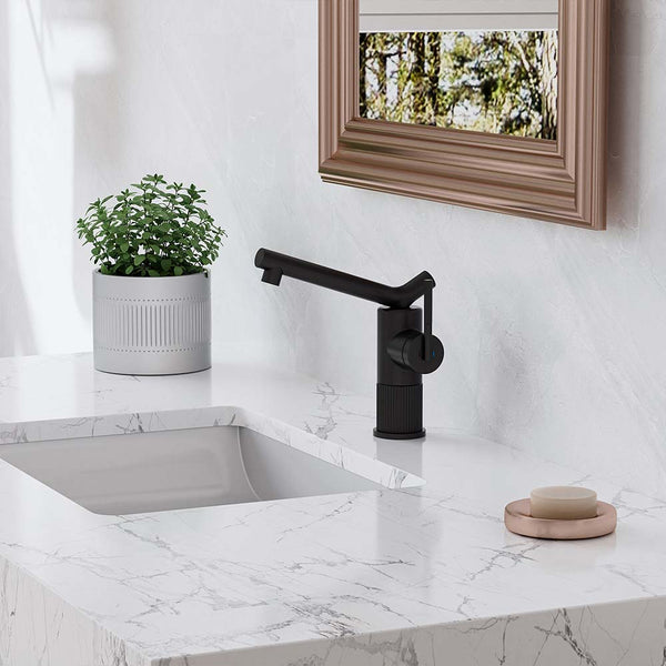 Modern black bathroom faucet on white marble vanity top